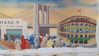 coney island boardwalk scene with Brooklyn Bridge in the back..